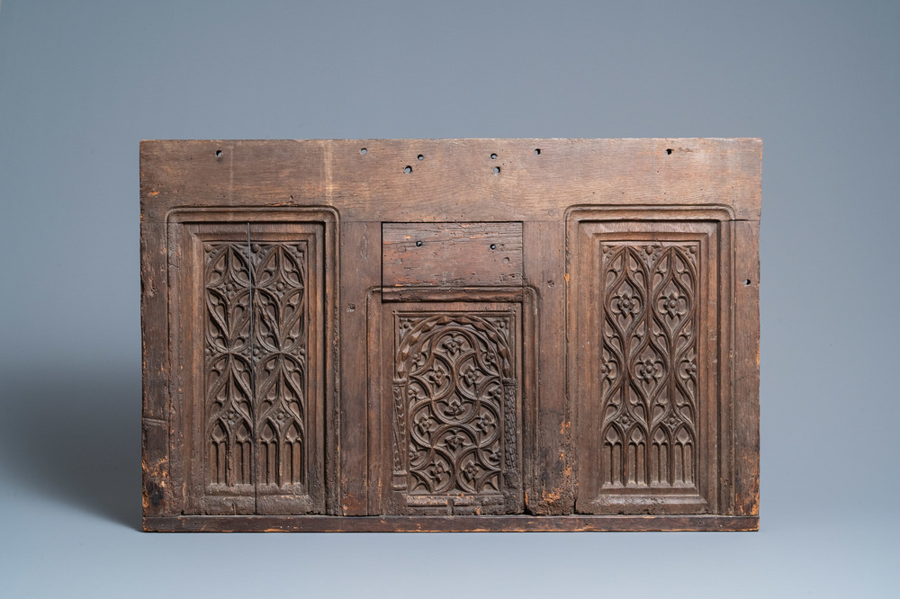 A carved oak front panel of a coffer with tracery panels, 15th C.