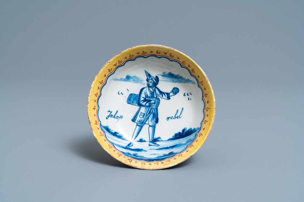 A polychrome Dutch Delft deep saucer dish inscribed 'Jakop rebel', 18th C.