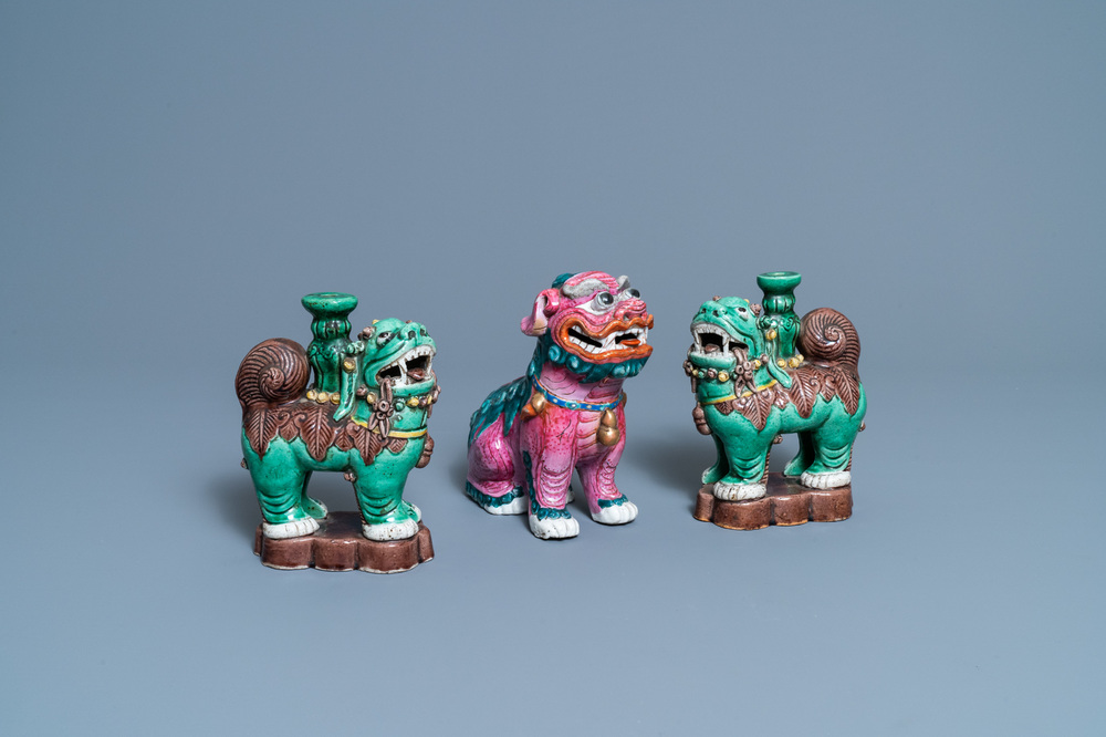 A Chinese famille rose model of a Buddhist lion and a pair of verte biscuit joss stick holders, 19th C.