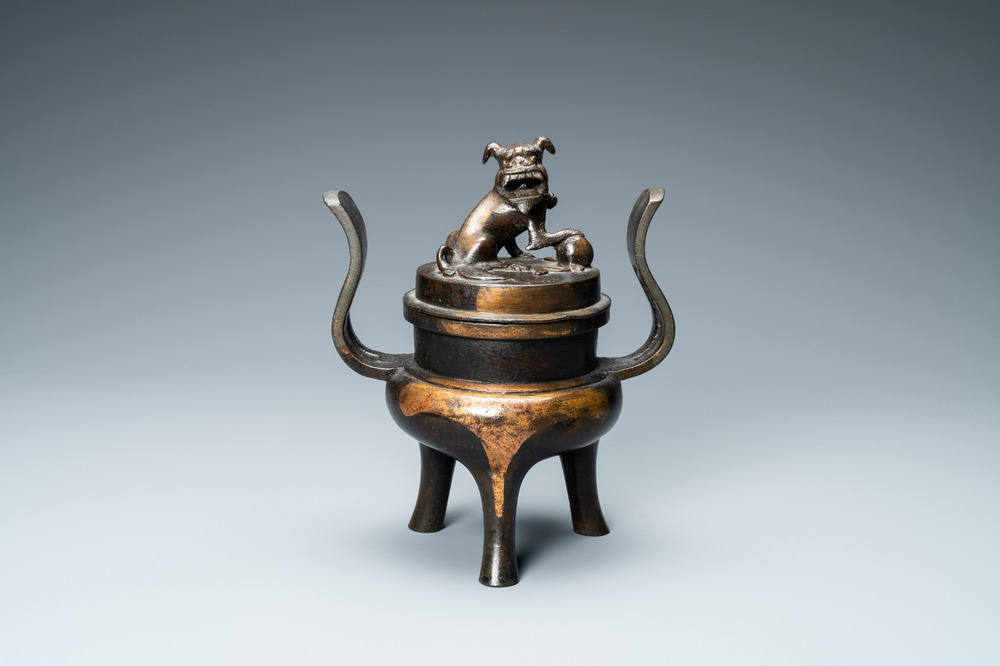 A Chinese partly gilded bronze tripod censer and cover, Ming