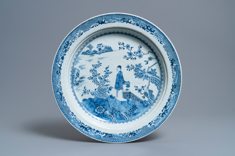 A large deep Chinese blue and white dish with a lady, Qianlong