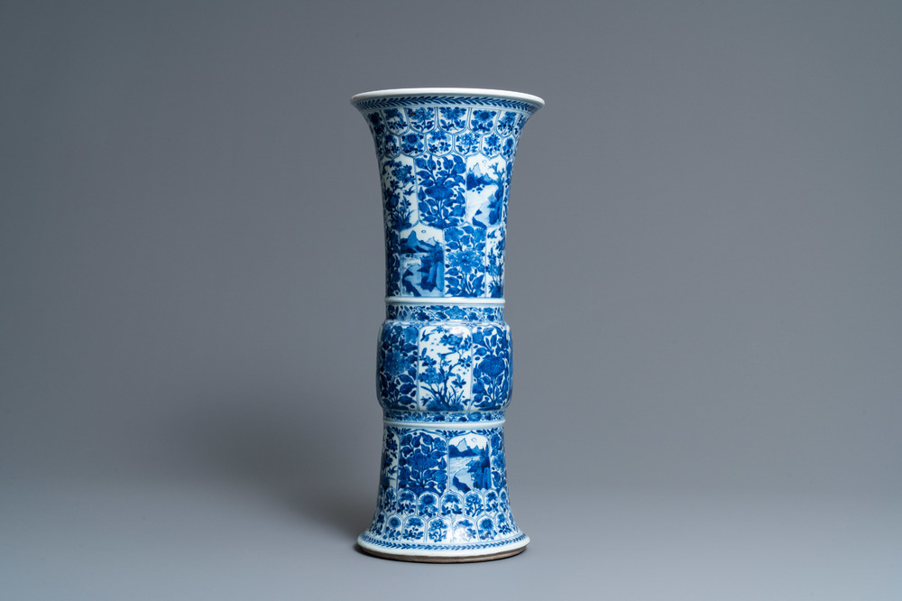 Een Chinese blauw-witte 'gu' vaas met florale en landschapspanelen, Kangxi