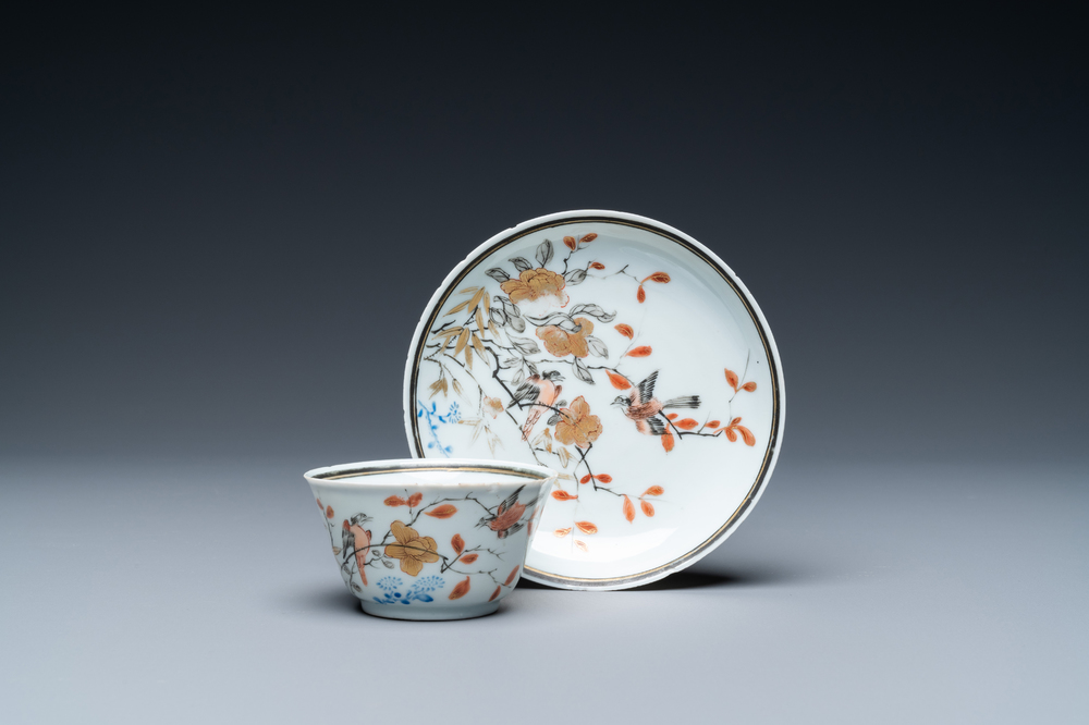 A Chinese grisaille, iron-red and gilt cup and saucer with birds near blossoming branches, Yongzheng