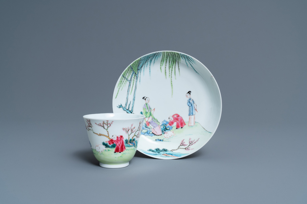 A Chinese famille rose cup and saucer with ladies and a boy playing with a rabbit, Yongzheng