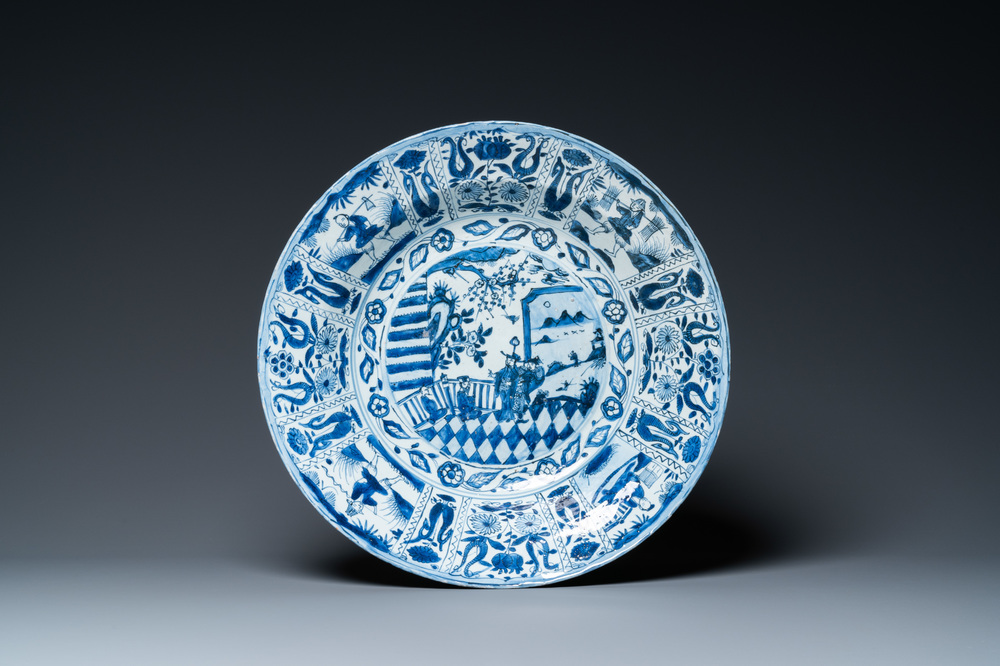 A large Chinese blue and white kraak porcelain dish with figures in a landscape, Wanli