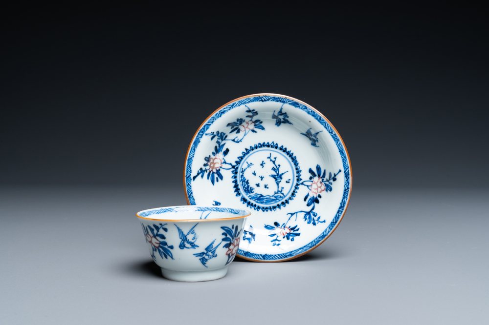 A Chinese blue, white and copper-red cup and saucer, Kangxi