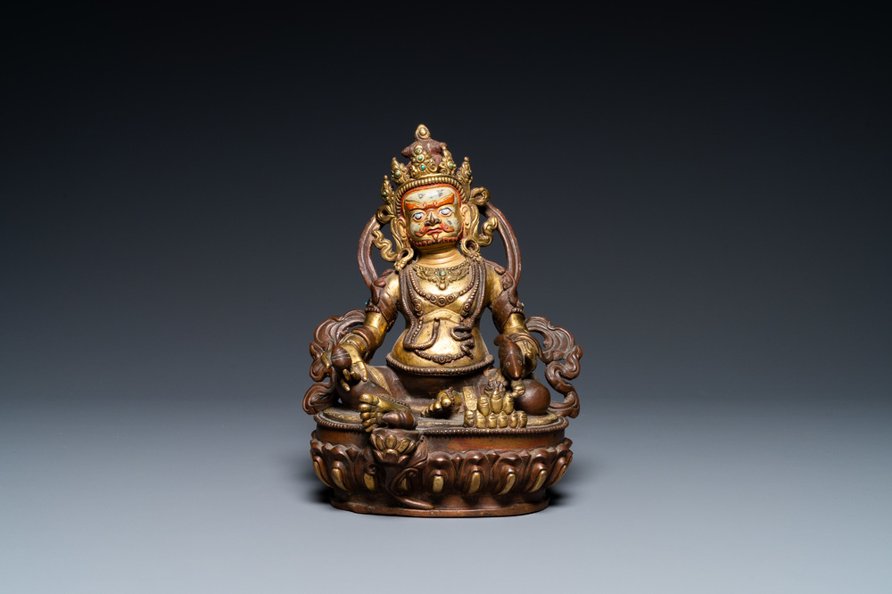 A Sino-Tibetan partly gilt bronze figure of Jambhala with inscriptions on the back, 19th C.