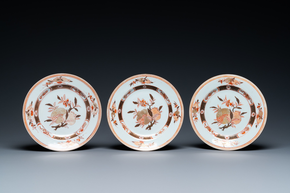 Three Chinese iron-red and gilt 'pomegranate' plates, Yongzheng