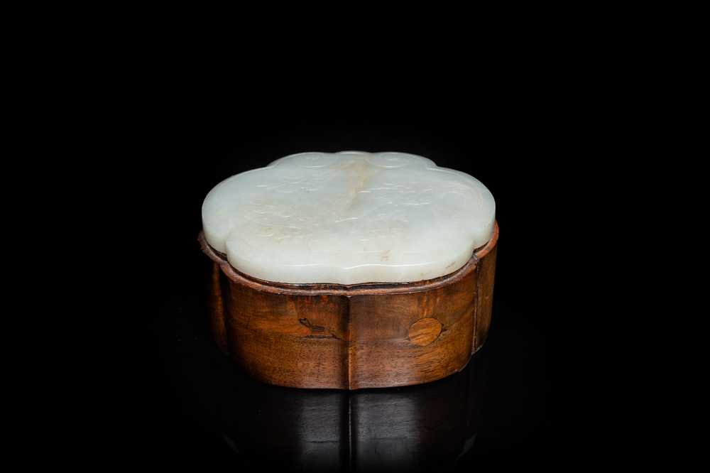 A Chinese wooden box with a white jade 'ruyi' plaque as cover, 18/19th C.
