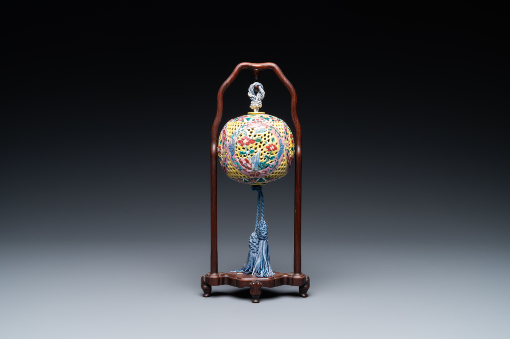 A Chinese reticulated famille rose fragrance ball, 19th C.