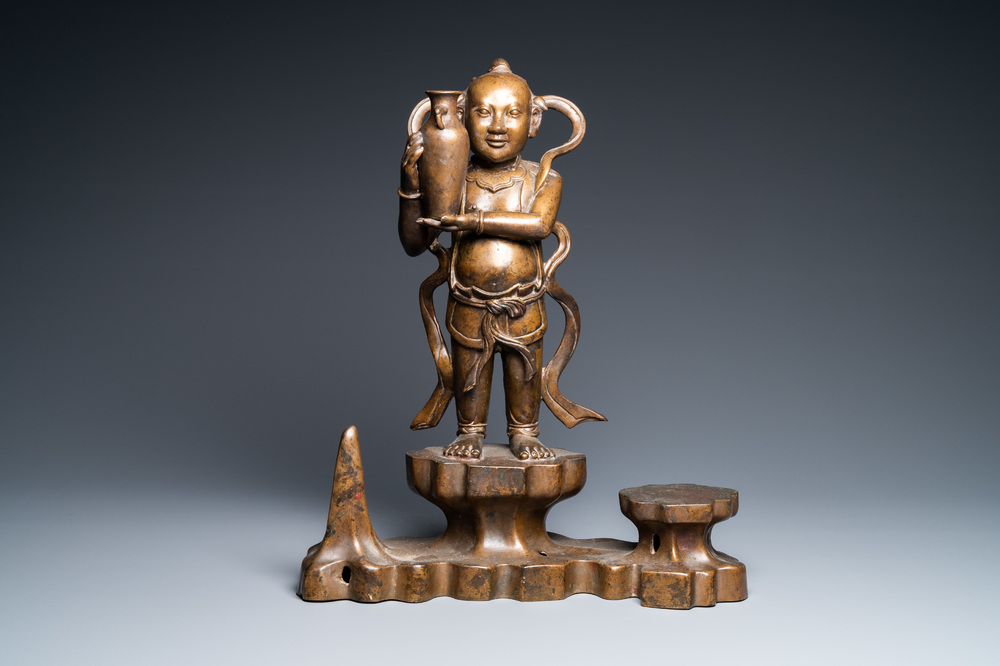 A large Chinese bronze figure of one of the Hoho twins holding a vase, Qing