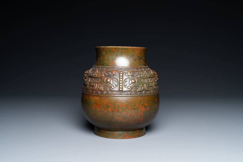 A Chinese bronze 'hu' vase with taotie masks, the base inscribed, 18/19th C.