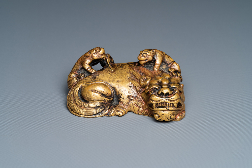 A Chinese gilt bronze 'lion with cubs' scroll weight, Qing