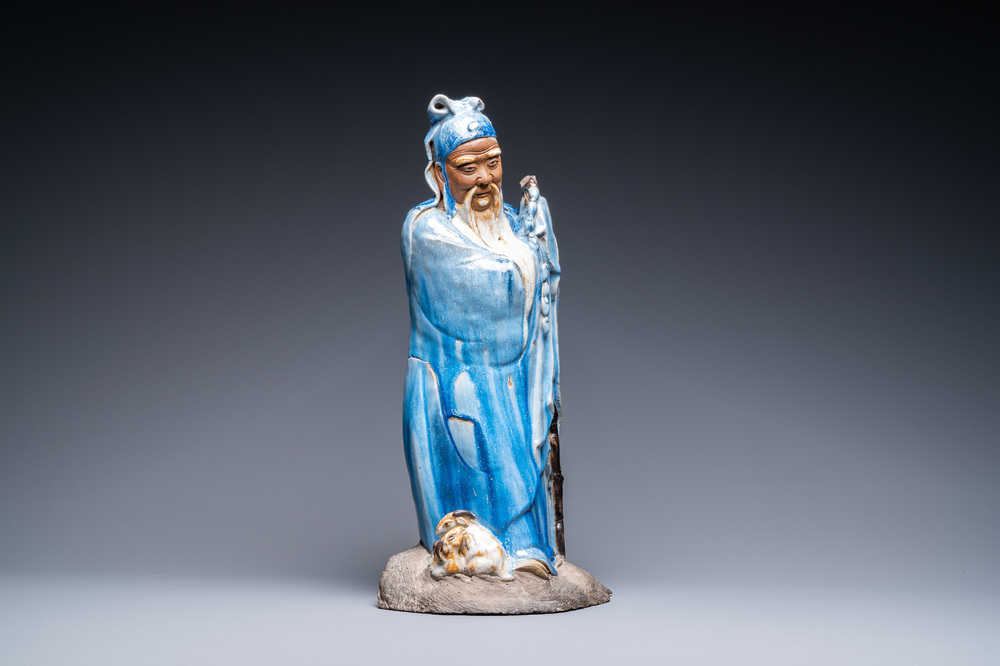 A large Chinese blue-glazed Shiwan pottery 'immortal' figure, 19th C.