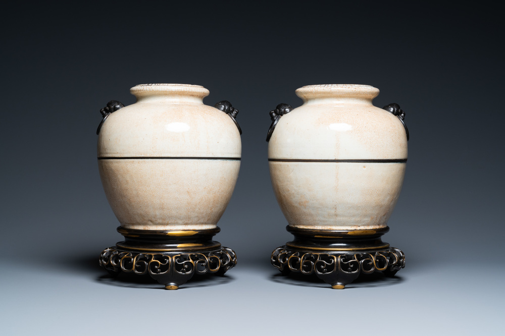 A pair of Chinese monochrome Nanking crackle-glazed vases on reticulated bronze stands, 19th C.