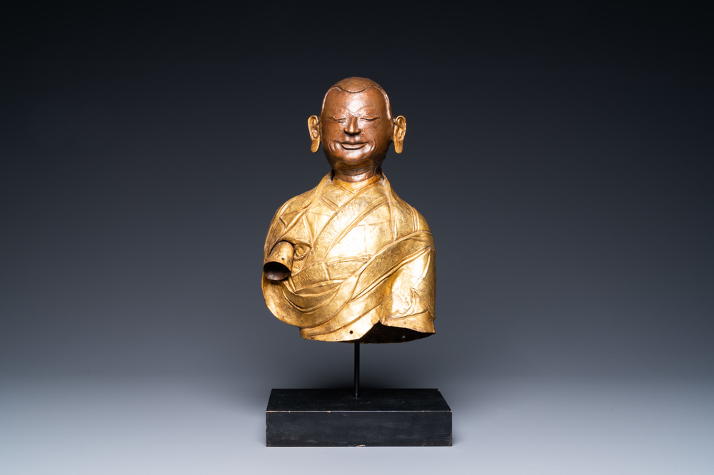 A Tibetan partly gilded brass bust of a Buddhist monk, 18th C.