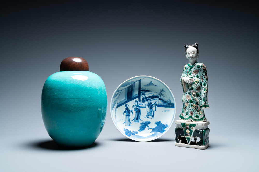 A Chinese verte biscuit figure, a green 'lotus' jar and a figurative blue and white plate, Kangxi and later