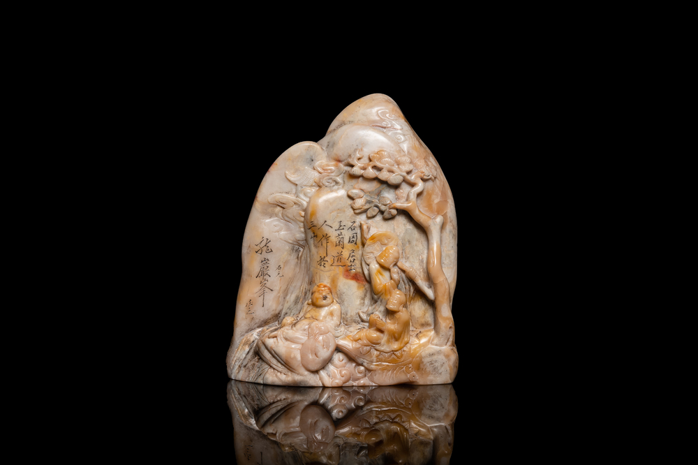 A Chinese Shoushan soapstone seal group depicting figures beneath a mountain, 19th C.