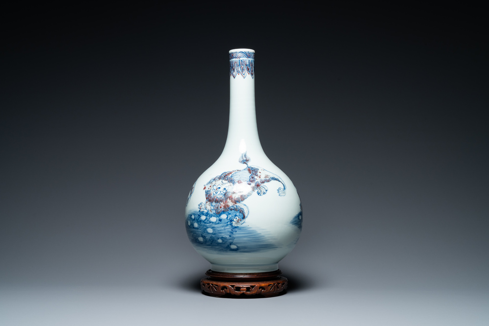 A Chinese blue, white and copper-red bottle vase with Buddhist lions, 20th C.