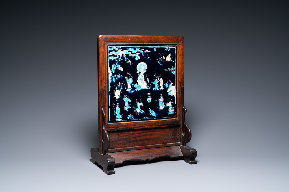 A Chinese square fahua plaque mounted in a wooden table screen, Ming