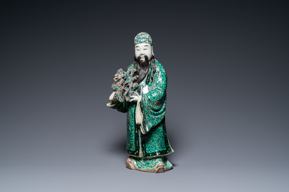 A Chinese verte biscuit figure of an immortal, 19th C.