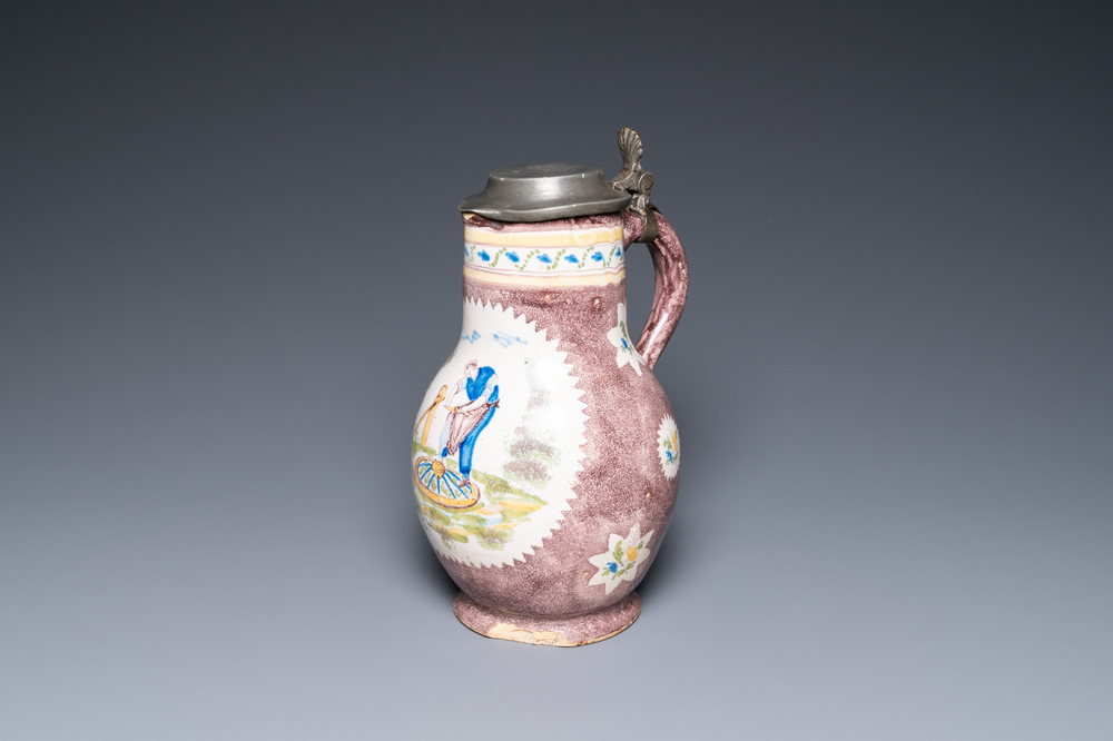 A polychrome Brussels faience ewer with a wheelwright, 18th C.
