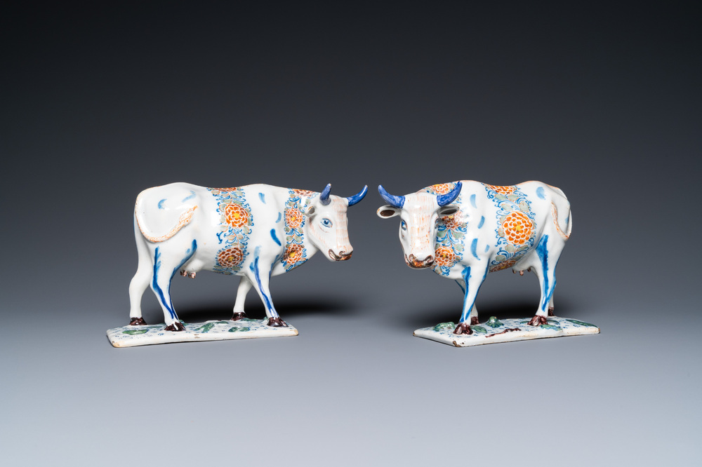 A pair of polychrome Dutch Delft cows on bases with frogs, 18th C.