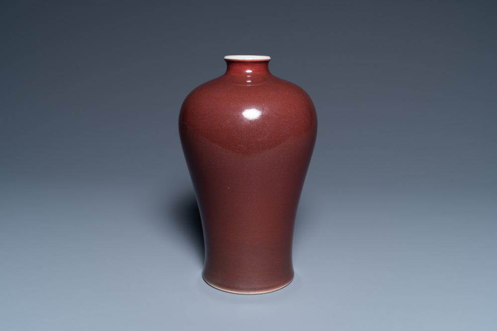 Un vase de forme 'meiping' en porcelaine de Chine rouge fonc&eacute; monochrome, marque et &eacute;poque de Qianlong