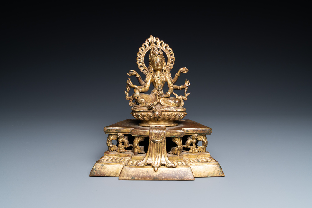 A Sino-Tibetan gilt bronze figure of Ushnishavijaya on a lotus throne with an inscription on the back, 18th C.