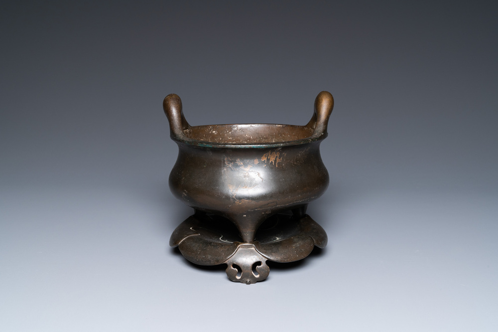 Un br&ucirc;le-parfum tripod en bronze sur support en forme de lotus, marque Yan Gu Tang, R&eacute;publique