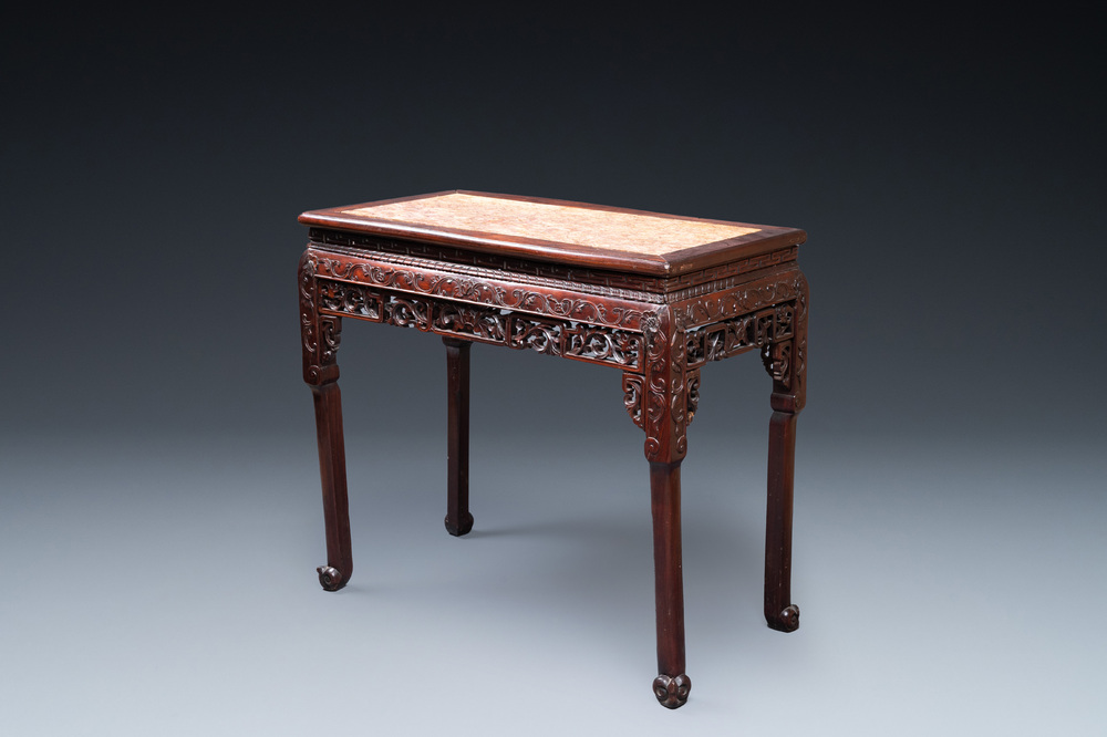 A Chinese rectangular carved wooden table with marble top, 19th C.