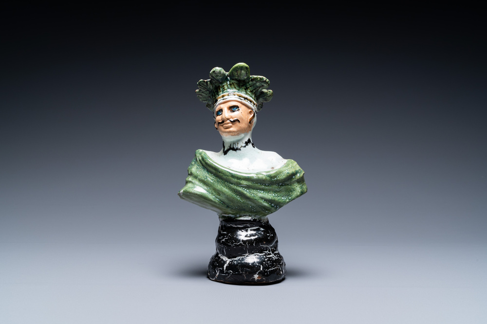 A polychrome French faience candlestick in the shape of a man, 18th C.