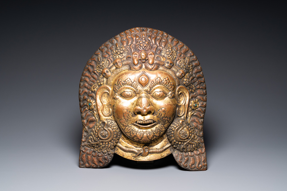 A large Tibetan gilt copper repouss&eacute; mask of Bhairava, Tibet or Nepal, 19th C.