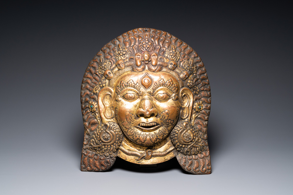 A large Tibetan gilt copper repouss&eacute; mask of Bhairava, Tibet or Nepal, 19th C.