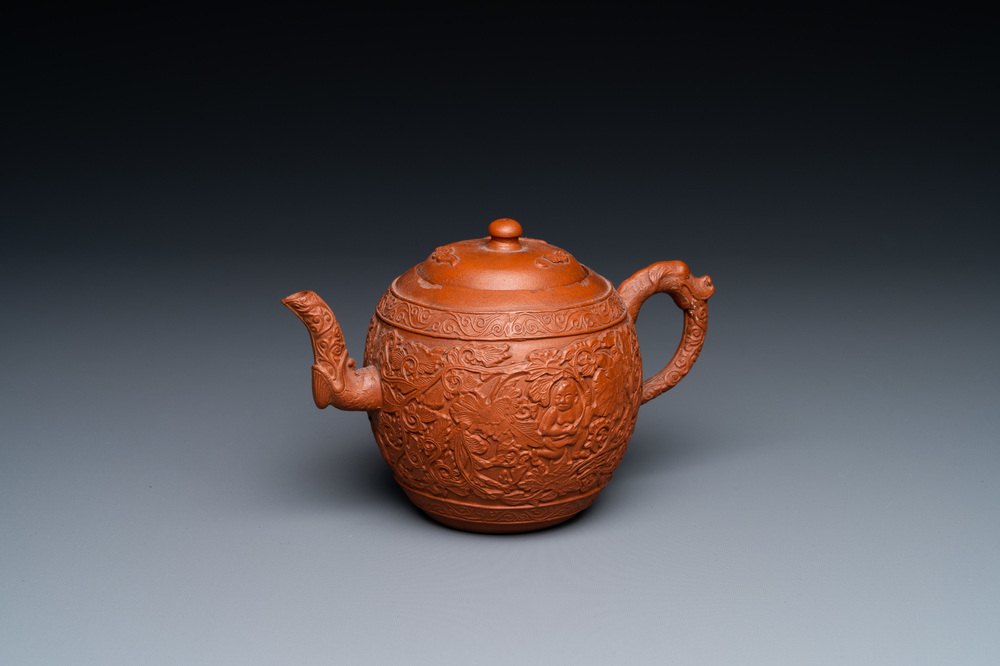 A Chinese Yixing stoneware teapot with boys among peony scrolls, Kangxi