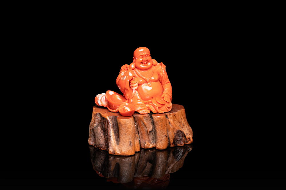 A Chinese carved red coral 'Buddha' figure, Republic
