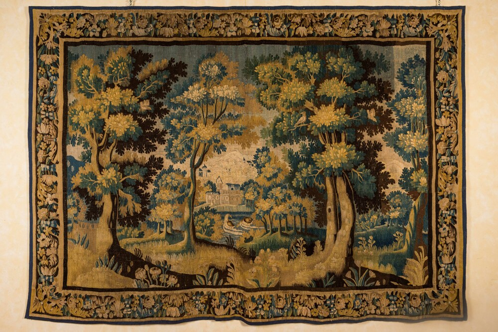 A Flemish wall tapestry with a forest view with a castle, 17th C.