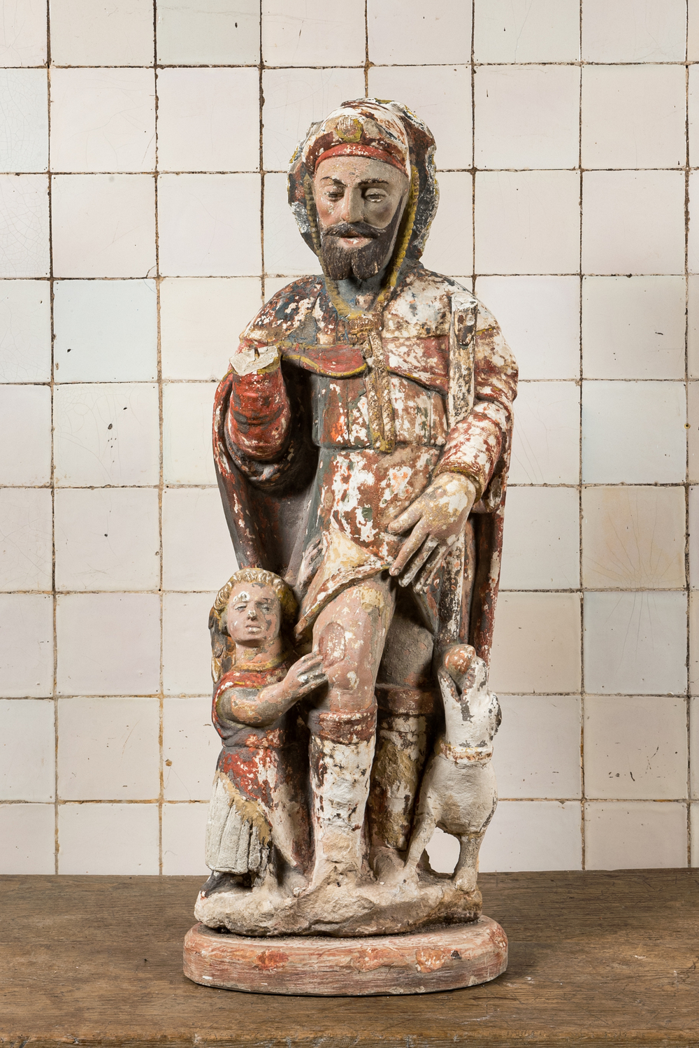 Een grote polychrome kalkstenen 'Sint-Rochus met kind en hond' groep, 17/18e eeuw