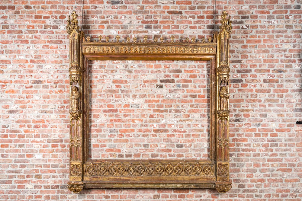 An impressive Gothic Revival carved and gilt wood frame with monks under canopies, 19th C.