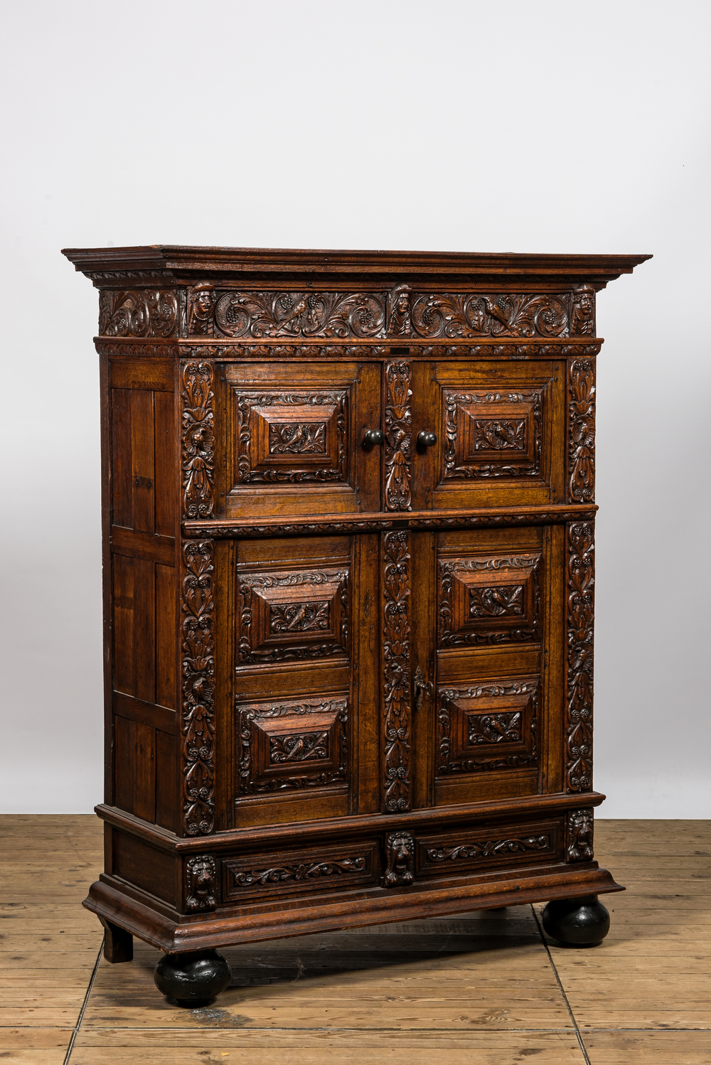 A finely sculpted Flemish oak four-door cabinet, late 17th C.