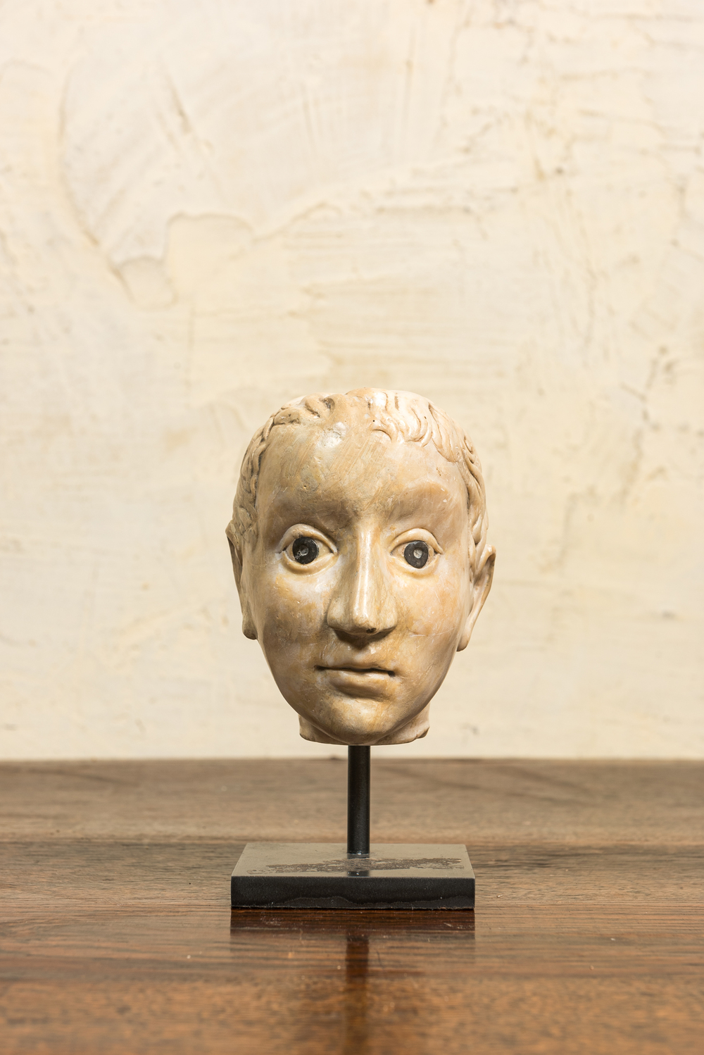 An Italian marble head in Roman-style with coins inlaid as eyes, probably 17th C.