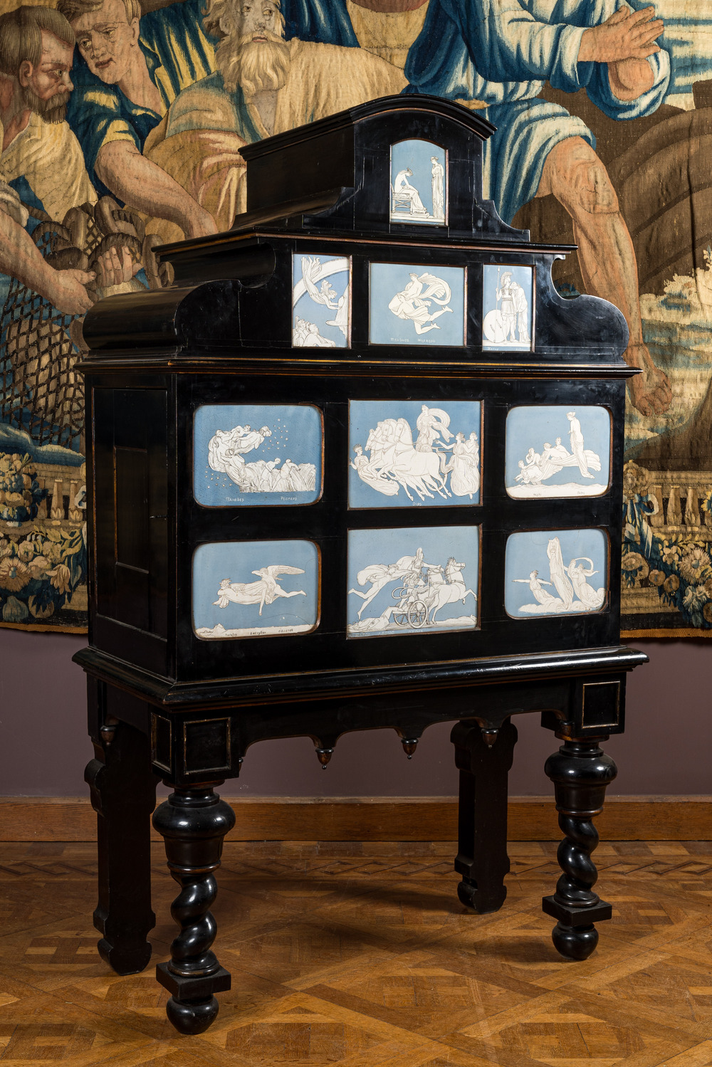 A most probably Greek ebonised wooden cabinet on foot with Wedgwood-style gods' and goddesses' plaques, 19/20th C.