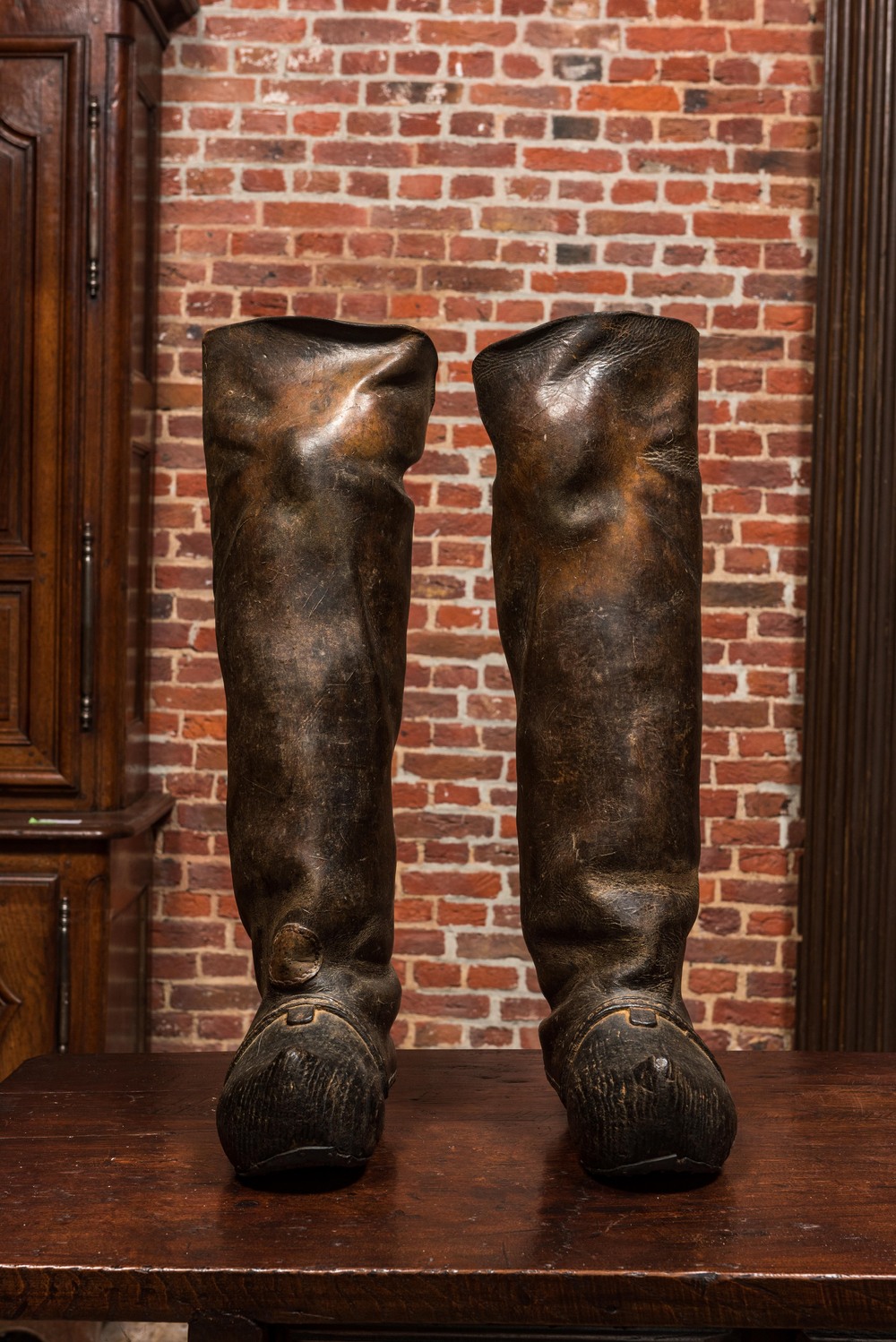 A pair of leather boots with wooden clogs, 19th C.