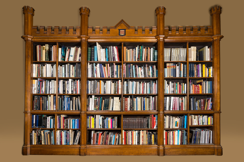 An oak open library bookcase with a castle-shaped crown, 19th C.