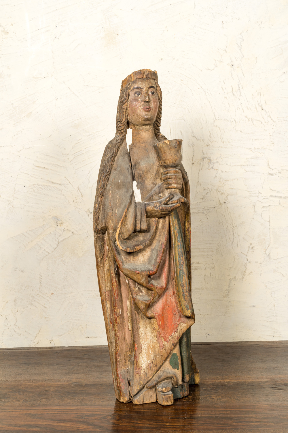 A German polychromed basswooden Saint Odilia holding a chalice, Middle-Rhein area, early 16th C.