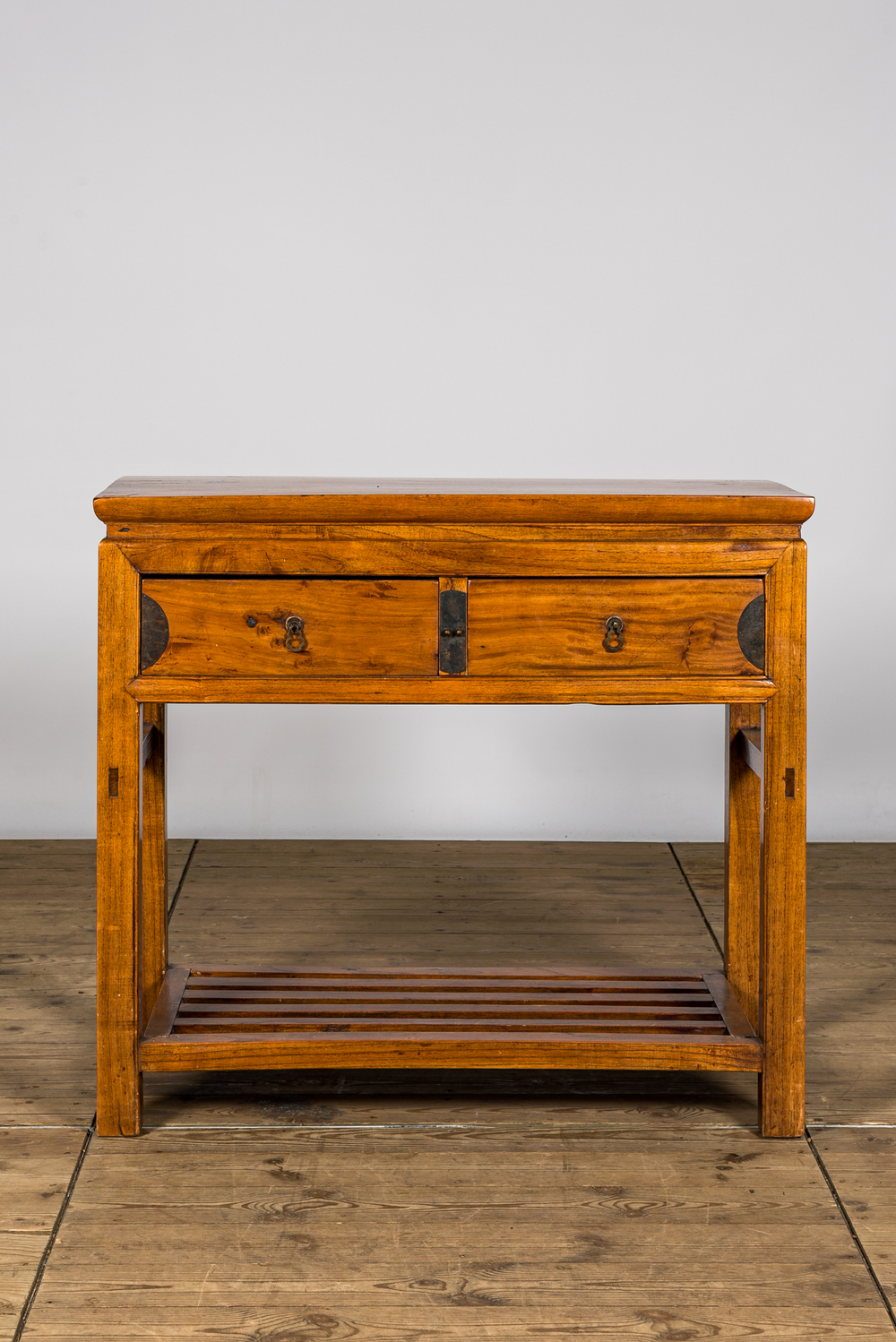 A Chinese wooden console with two drawers, 20th C.