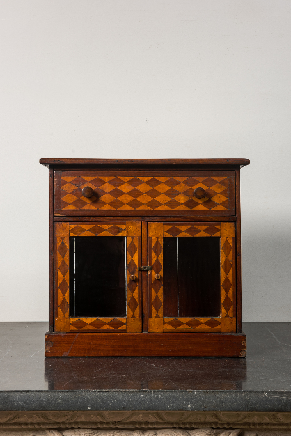 An inlaid wooden display cabinet, 19th C.