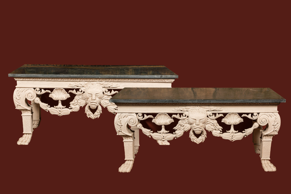 A pair of imposing white patinated consoles with a central mascaron and bluestone top, 19/20th C.