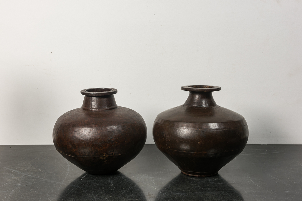 Two vases composed of riveted cast iron panels, 20th C.