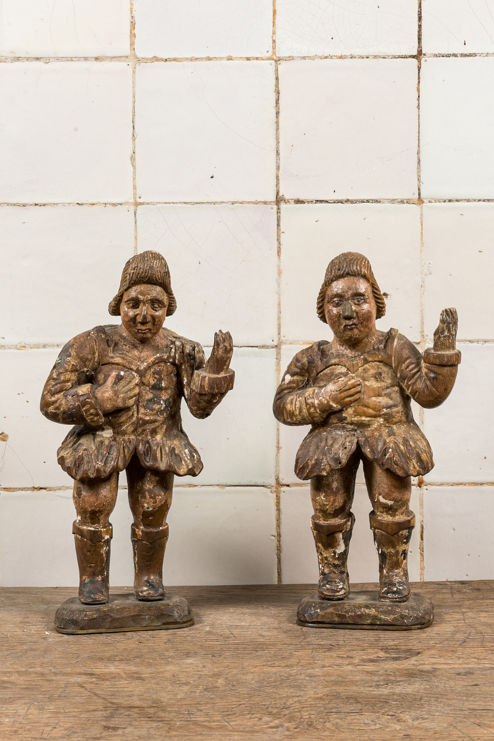 A pair of polychromed and partly gilt walnut sculptures of actors, 17/18th C.